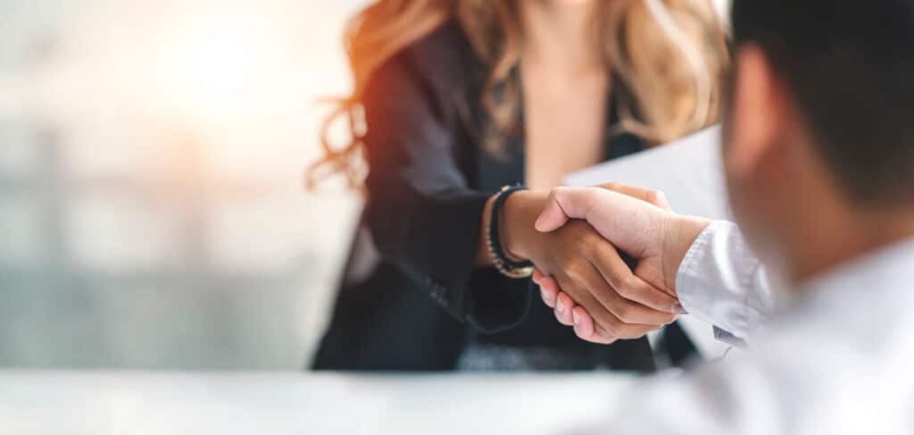 Female attorney shaking hands with someone.