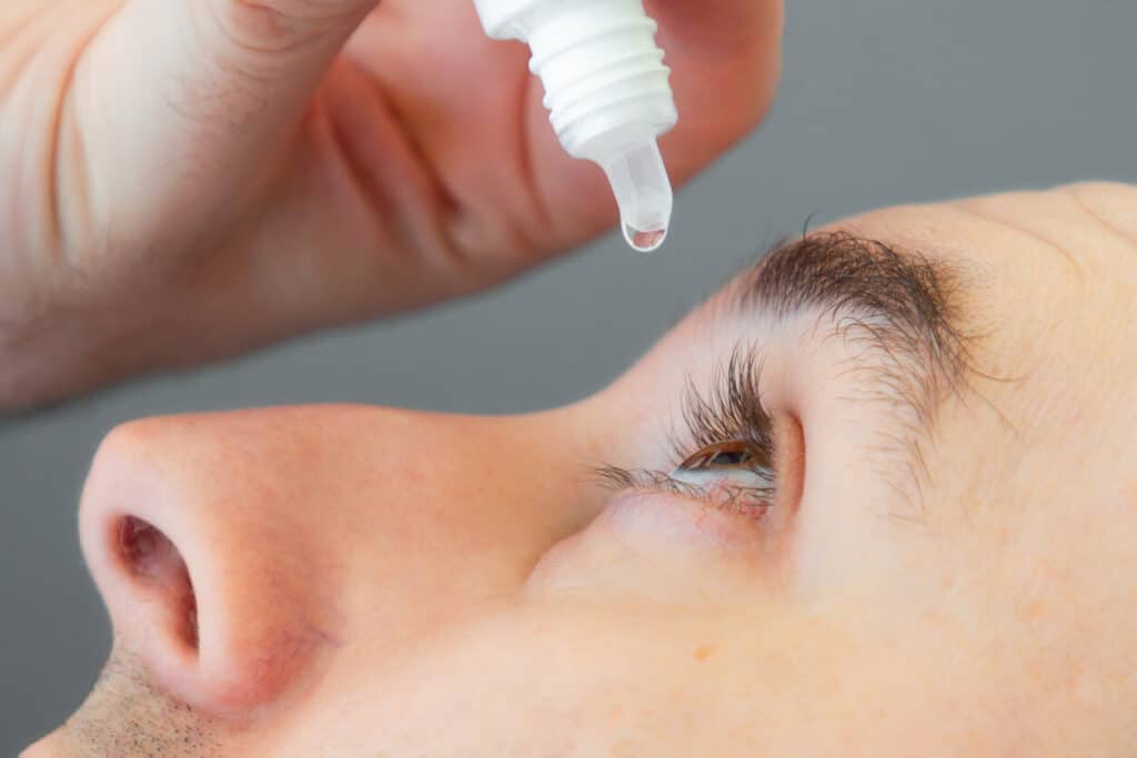 A man using eyedrops.