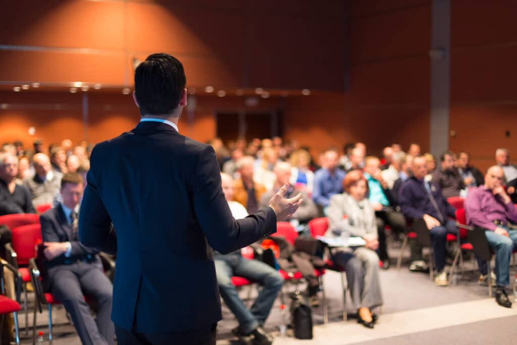 man speaking at conference